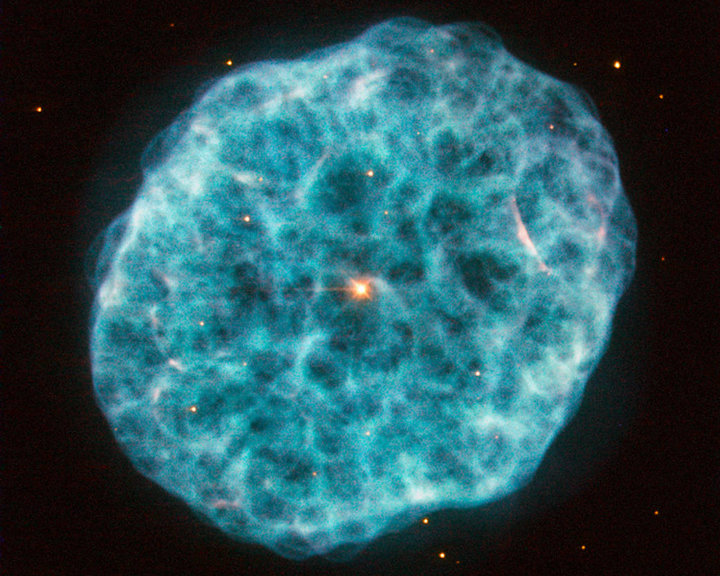 Niebieski, poszarpany obłok w owalnym kształcie. W jego centrum pomarańczowa gwiazda.