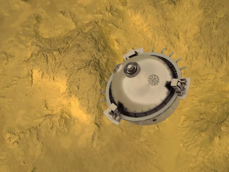 Szara kulista sonda ponad żółtym, górzystym terenem