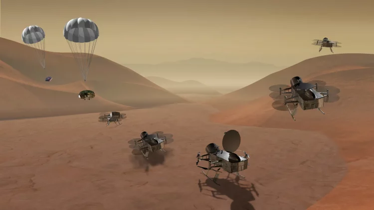 Na tle pustynnego krajobrazu ilustracja pojazdu w różnych etapach lądowania i startu. Od lewej pojazd opadający na spadochronie, po odczepieniu spadochronu, na powierzchni, wznoszący się na własnych śmigłach.